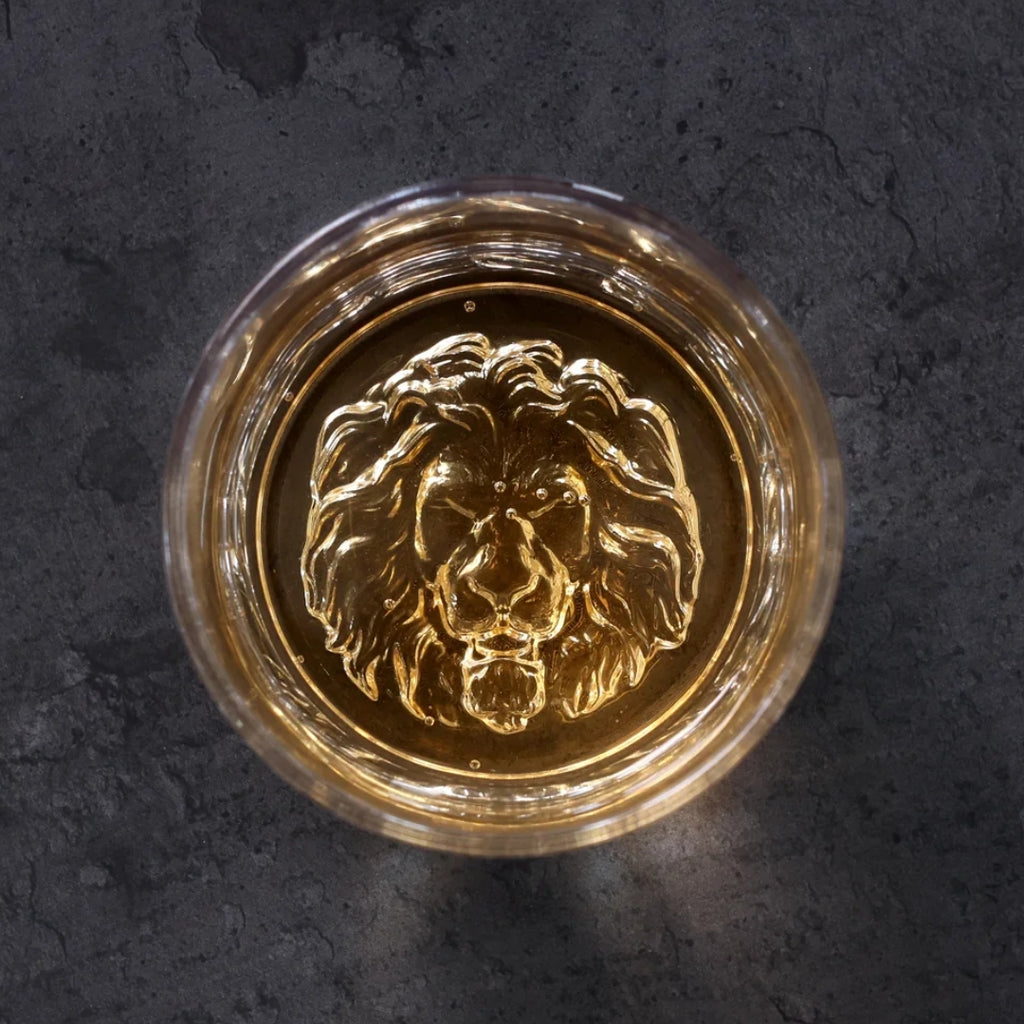 Lion whiskey glass Unique whiskey glass Whiskey tumbler with lion design Collectible lion themed whiskey glass Novelty whiskey glass Lion head whiskey glass Lion engraved whiskey glass Lion motif whiskey tumbler Lion-shaped whiskey glass Lion emblem whiskey glass