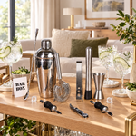 11-piece stainless steel cocktail shaker set on a bar cart with gin and tonics