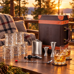 Brown leatherette portable bar set with 6 whiskey glasses on a cabin terrace at sunset